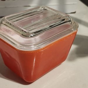 Red Pyrex refrigerator jar and lid.